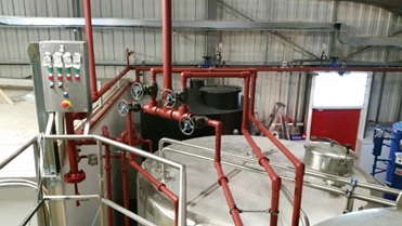 A low pressure process steam system using heavy grade BS EN 10255 steel tube with a red oxide primer painted finish